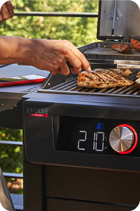 Person cooking on a Char-Broil electric grill.