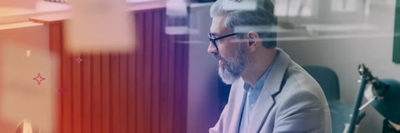 Business consultant in a suit reviewing AI-generated analysis on a laptop.
