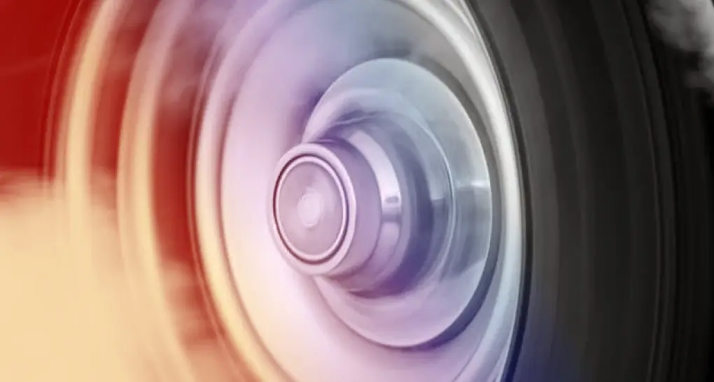 A high-speed motion blur of a spinning mechanical wheel with smoke accents, representing engineering team momentum and rapid software roadmap velocity.